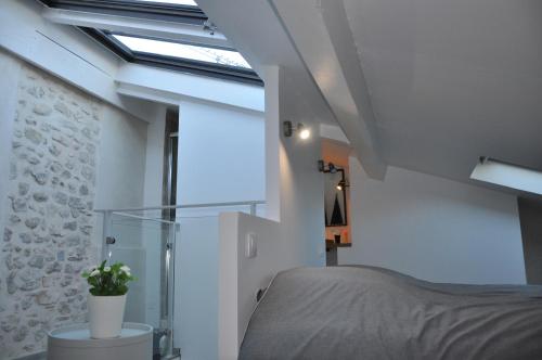 a bedroom with a bed and a window at Holiday in Arles -Maison du Centre Historique in Arles