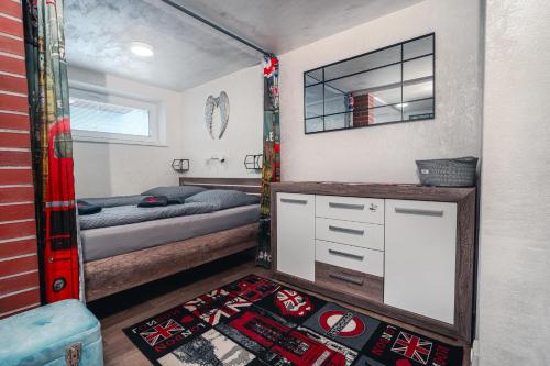 a small bedroom with a bed and a mirror at Penzion U Hada in Velké Pavlovice