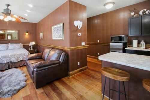 a living room with a couch and a bed and a kitchen at Safari Cottage in Jacksonville