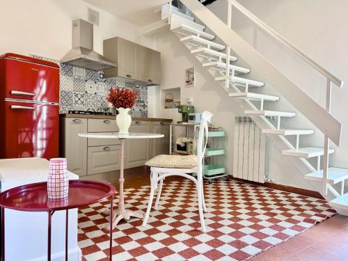 a kitchen with a staircase and a table and chairs at Garden House - InBorgo in Acquasparta