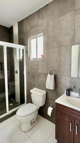 a bathroom with a toilet and a sink at Departamento completo y equipado con 2 habitaciones in León