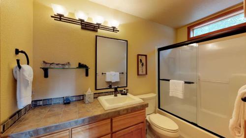 a bathroom with a toilet and a sink and a shower at 6 Summit View Lane in Sunriver