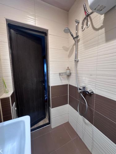a bathroom with a shower with a glass door at Central Stara Zagora Apartment in Stara Zagora