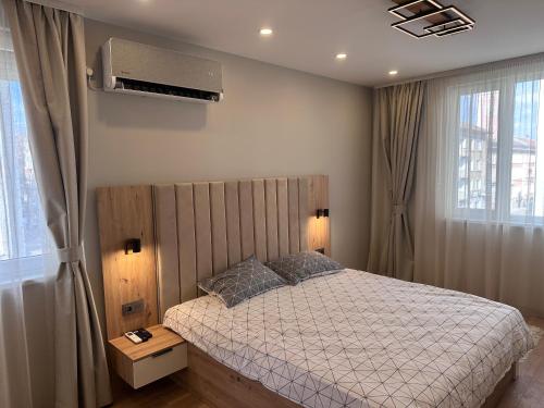 a bedroom with a bed and a air conditioner at Central Stara Zagora Apartment in Stara Zagora