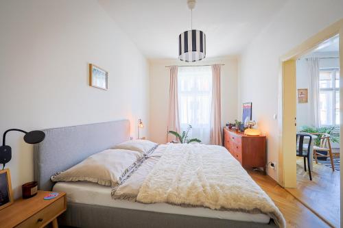 a bedroom with a bed and a table and a desk at Apartmán v srdci Tábora in Tábor