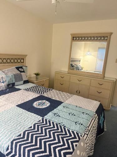 a bedroom with a bed and a large window at Vermont By The Sea in Cape May