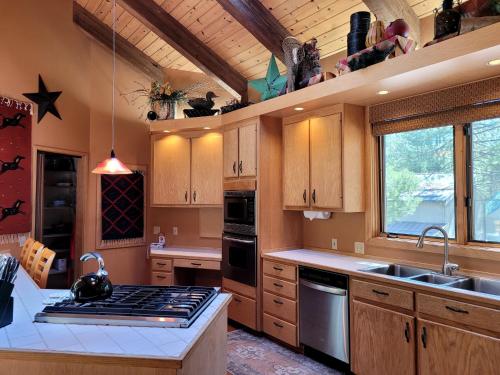 a kitchen with wooden cabinets and a stove top oven at 6 Colonial Lane in Sunriver