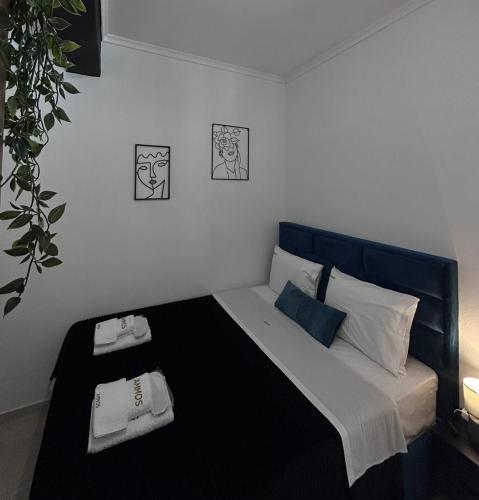 a bedroom with a bed with two towels on it at Ammos in Kavála