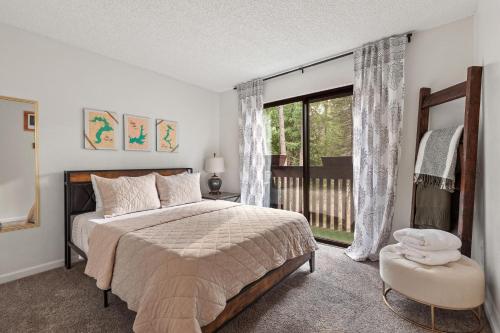 a bedroom with a bed and a large window at Twin Lakes in Rathdrum, ID in Rathdrum