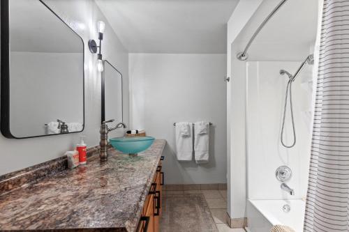a bathroom with a blue sink and a shower at Twin Lakes in Rathdrum, ID in Rathdrum