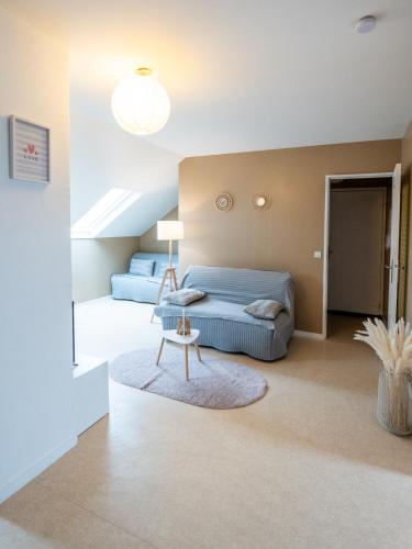 a bedroom with a bed and a table at Cosy app near sea in Cabourg