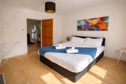 a bedroom with a large bed with towels on it at Urban in Southampton