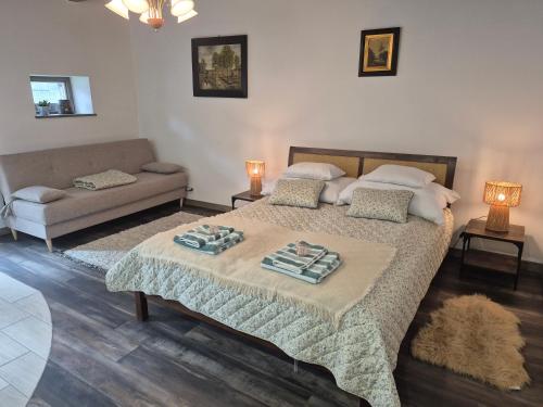 a bedroom with a bed and a couch at Gerendás in Szilvásvárad