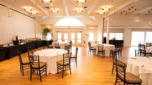 a banquet hall with tables and chairs in a room at Taboo Muskoka in Gravenhurst