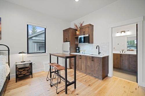 a kitchen with wooden cabinets and a table in a room at 18136-2 Forestbrook Loop in Bend