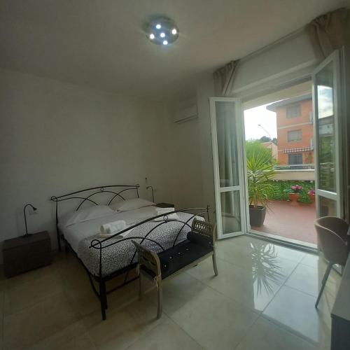 a bedroom with a bed and a sliding glass door at Casa Manzoni 45 in Scandicci