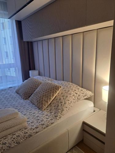 a white bed with two pillows on it at Classic&Modern Suite in Kętrzyn