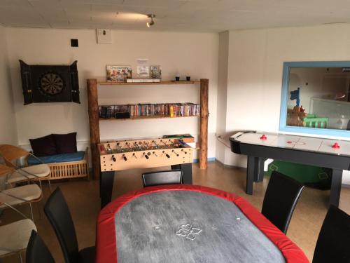 a room with a ping pong table and a desk at Hestkær Family Rooms Summer Camp in Krogager