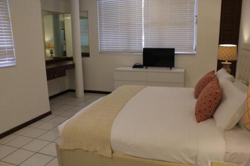 een slaapkamer met een bed en een laptop op een bureau bij Hosteria del Mar in San Juan