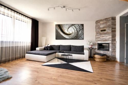 a living room with a couch and a fireplace at Holiday House Jana in Muráň