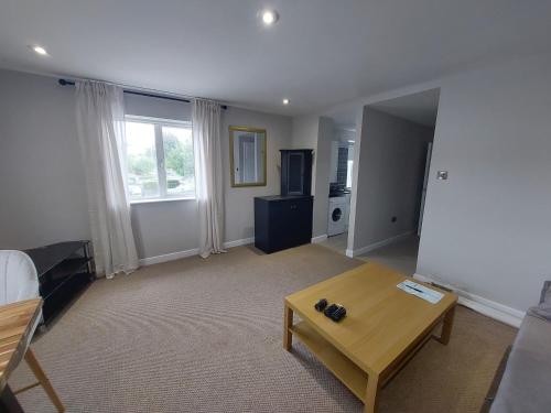 a living room with a couch and a table at Greenmount - 1 Bed Apartment in Naas