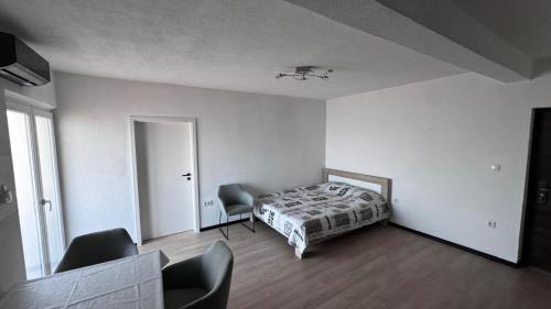 a bedroom with a bed and a table and chairs at Barth Apartments in Donji Štoj