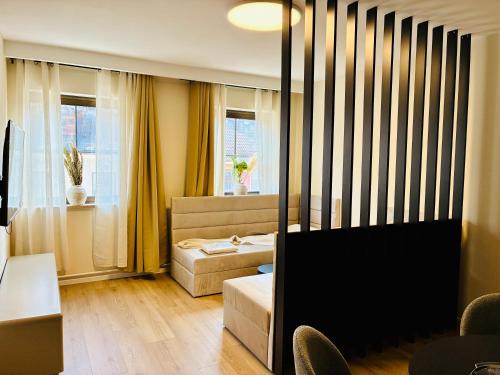 a hotel room with a bed and a window at Schwanstein Apartments Füssen ZENTRUM in Füssen