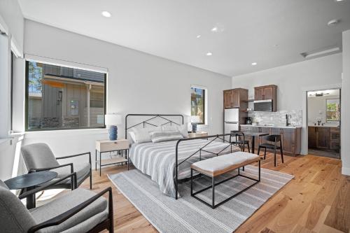 a white bedroom with a bed and a kitchen at 18163-2 Forestbrook Loop in Bend