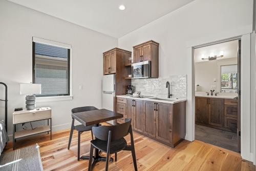 a kitchen with wooden cabinets and a table and chairs at 18163-2 Forestbrook Loop in Bend