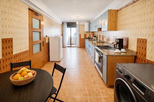 a kitchen with a table with a bowl of fruit on it at Residence Mly youssef appart in Safi