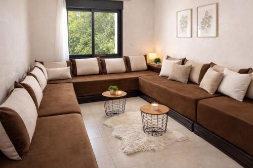 a large living room with a large brown couch at Residence Mly youssef appart in Safi