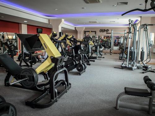 a gym with a bunch of treadms and machines at Hotel Olimp Business & Spa in Wejherowo