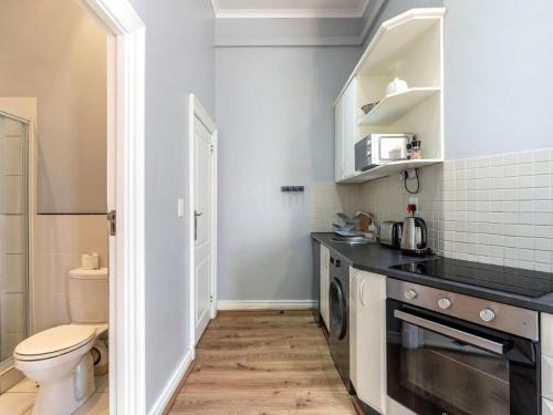 a small kitchen with a sink and a toilet at Long Street Boutique Hotel in Cape Town