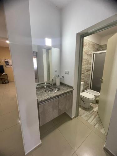 a bathroom with a sink and a toilet at La Buena Memoria in San Juan