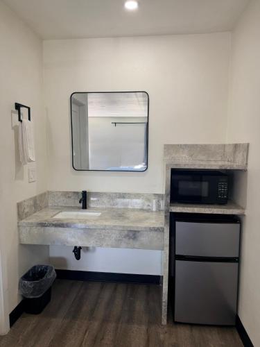 a bathroom with a sink and a mirror at Scenic Motel - El Monte in El Monte