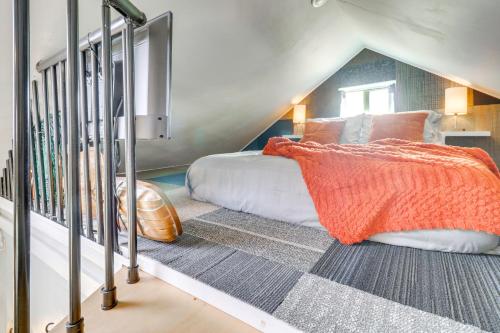 a bedroom with a bed with an orange blanket at Walk to Downtown! ABQ Couple's Studio w/ Deck in Albuquerque
