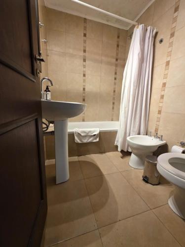 a bathroom with a sink and a toilet at Caseros Desings Salta in Salta