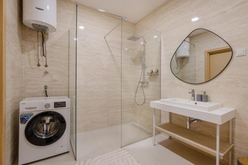 a bathroom with a washing machine and a sink at River side apartment B3 in Herceg-Novi