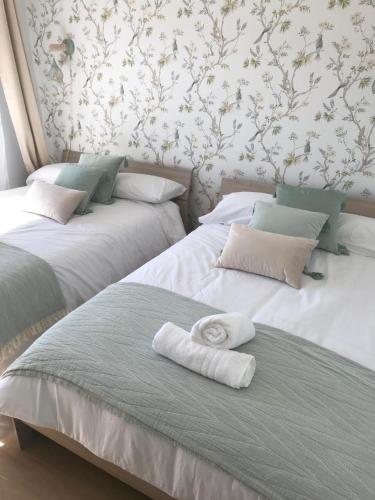 two beds sitting next to each other with towels on them at Marcemar in Borbén