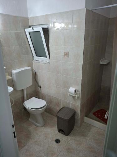 a bathroom with a toilet and a sink and a mirror at Κτήμα Καρνέση 2 in Loutra Edipsou