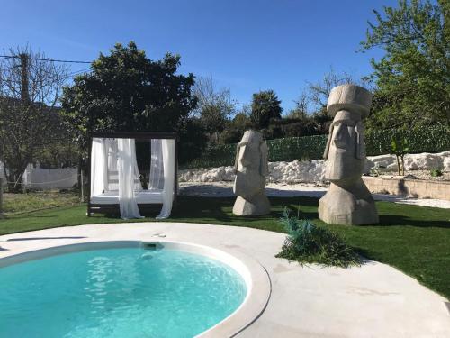 a swimming pool in a yard with a chair at Marcemar in Borbén