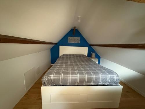 a bedroom with a bed in a attic at Logis cosy avec piscine in Saint-Josse