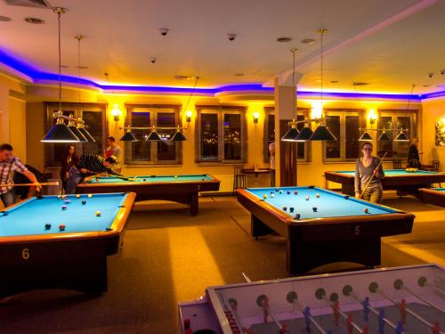 a room with several pool tables and ping pong balls at Hotel Olimp Business & Spa in Wejherowo