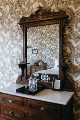 a bedroom with a dresser with a mirror on it at Cosmopolitan Hotel in San Diego