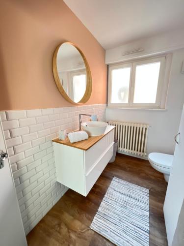 a bathroom with a sink and a mirror at Au perron avec garage et balcon à Ribeauville in Ribeauvillé