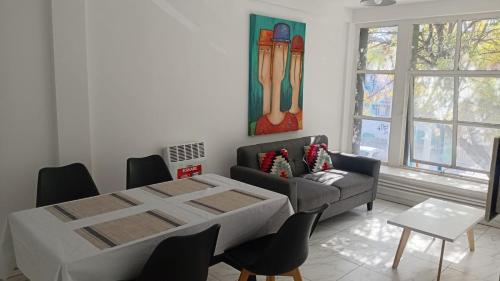 a living room with a table and a couch at Departamento centro Gral Roca in General Roca