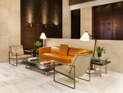 a living room with a couch and chairs at Porter Square Hotel in Cambridge