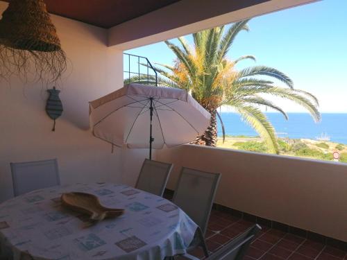 a dining room with a table and a view of the ocean at Apartamento Mar Azul-Ocean View in Lagos