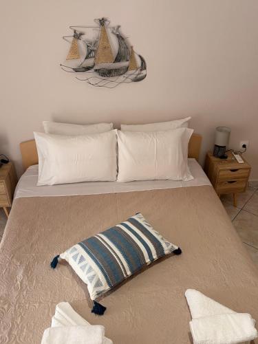 a bed with two pillows on top of it at Summer Comfort Apartment in Nea Kallikrateia