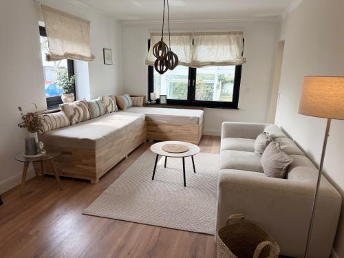 a living room with a couch and a table at WohlfühlWerk L7 in Mechernich